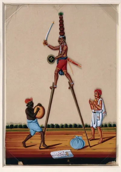 Street performers: an acrobat on stilts while the other two provide background music for the act