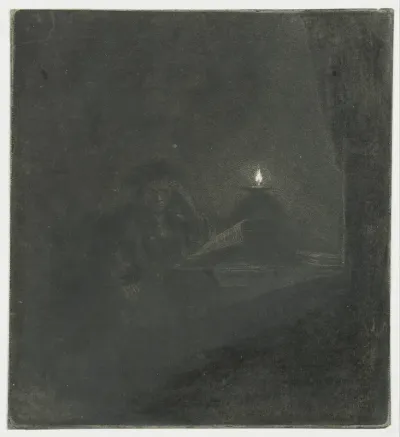 Student at a table by candlelight
