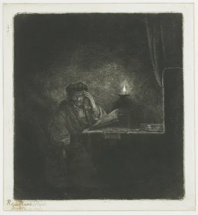 Student at a table by candlelight