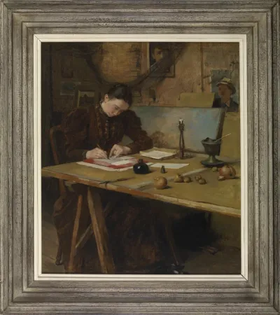 Studio interior with a woman writing