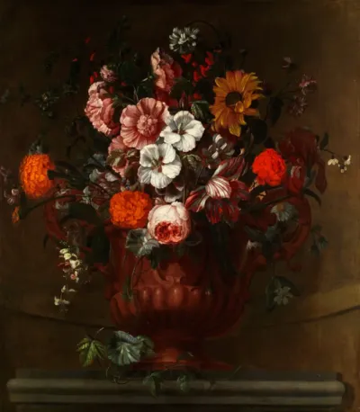 Summer flowers and bush blossoms in a gold-plated vase on a stone ledge