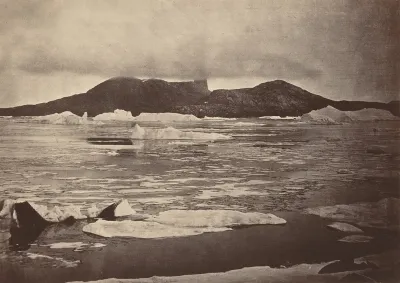 The Arctic Regions: No. 92.* The Devil's Thumb partially enveloped in a fog, with the first of the drift Ice from the pack, which was being forced towards the land, from which we escaped through a narrow lead; had we been hemmed in, we should have ha