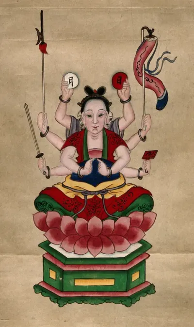 The deity Guanyin (Kuan Yin) seated on a lotus throne with eight arms, carrying a sword, axe, lantern, a swastika and two Chinese characters