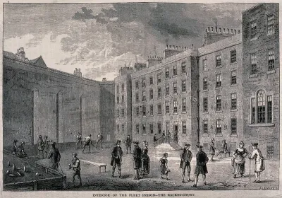 The Fleet Prison, London: the courtyard, with prisoners playing racquets while others stand and talk