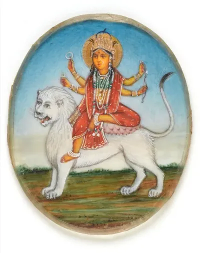 The goddess Durga, with four arms, riding on a white lion