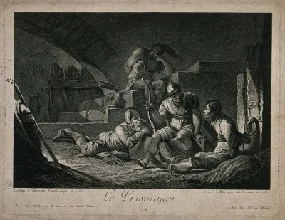 The guards in charge of a prisoner chained to the wall are talking to him
