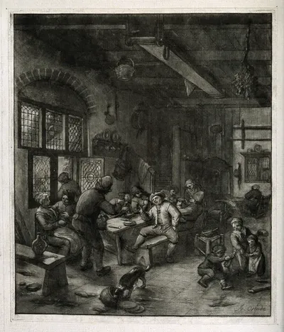 The interior of a tavern with men and women carousing at a table and children on the floor