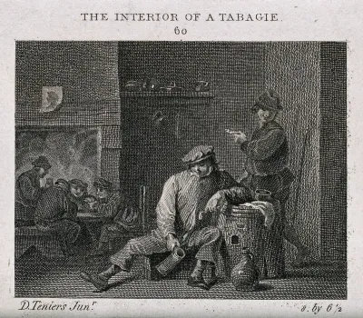 The interior of a tavern with men smoking and drinking by a barrel table and playing cards by the fire