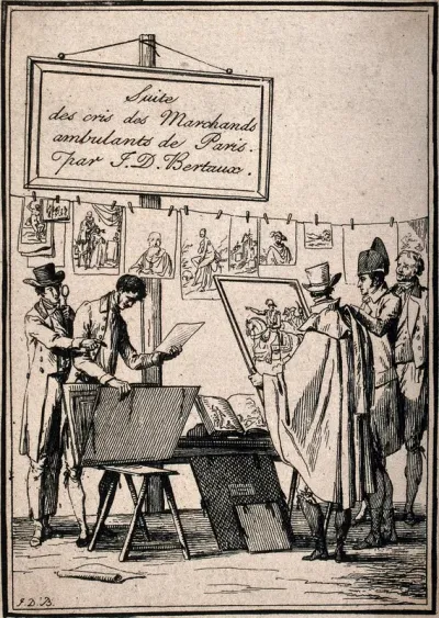 The stall of a print seller in Paris: customers look at prints pegged on a line and in portfolios