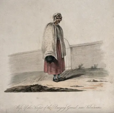 The wife of the keeper of the burying ground near Valenciennes standing outside the gate of the cemetery