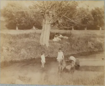 Three Children and a Dog Playing in the Creek, July 4