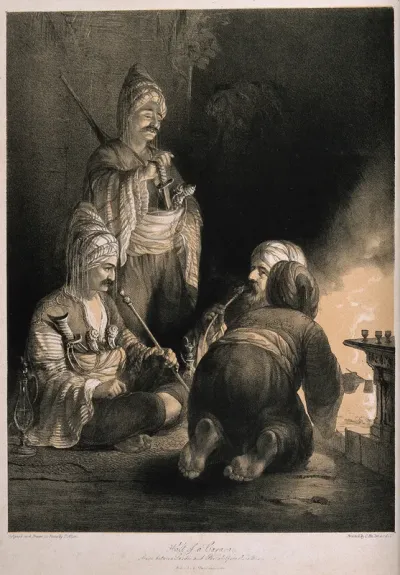 Three Turkish soldiers gathered round a fire in the dark, smoking pipes