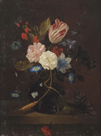 Tulip, a cornflower, roses, a carnation and other flowers in a glass vase on a ledge