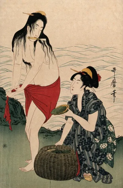 Two amas (women divers) on shore: one, who has just brought up a shellfish, holds a trowel in her teeth as she wrings out her skirt, while the other woman places the shellfish in a basket