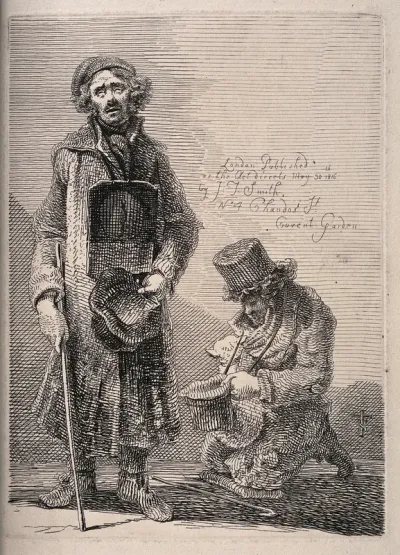Two blind beggars, one stands with a placard around his neck and hat, the other kneels with a dog on his lap
