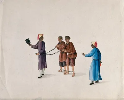 Two Chinese prisoners are led by chains