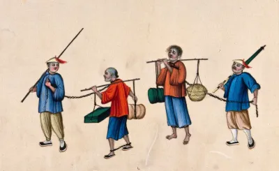 Two Chinese prisoners carrying heavy loads on poles balanced on their shoulders: the men have their legs shackled and are led by two other men, who hold the long chains attached to the prisoners' necks
