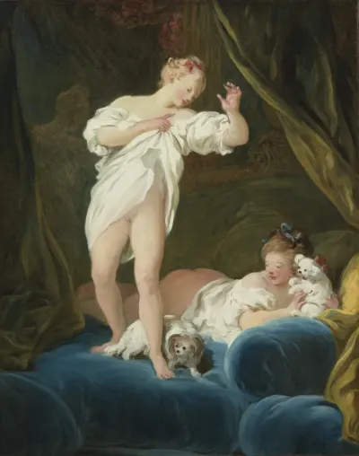 Two girls on a bed playing with their dogs