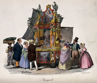 Two groups of customers buying water to drink from a large ornate stand staffed by a man and a woman