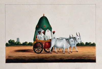 Two Indian men in a bullock cart with a curtained canopy on top and a small dome