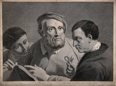 Two men and a boy read from a book, one man holds a magnifying glass