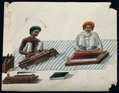 Two men binding books