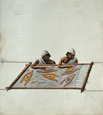Two men embroidering a piece of cloth stretched out on a frame