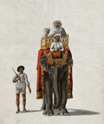 Two men riding on a elephant, along with the mahout, as a guard walks alongside