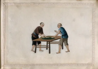 Two men rolling tea leaves by hand, to aid the oxidation process