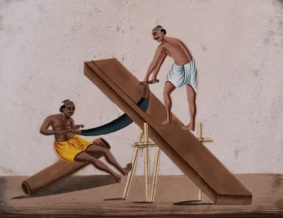 Two men sawing a large block of wood