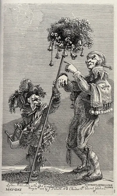 Two performing street entertainers carrying bells and performing on the street