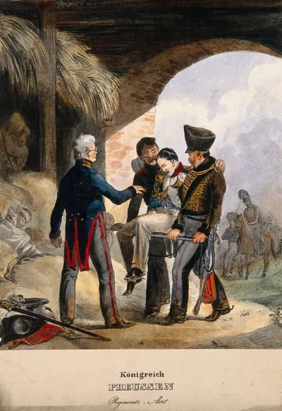 Two uniformed German soldiers carrying in a battle victim to a military doctor who waits in a barn