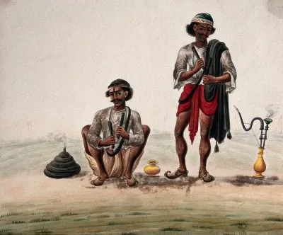 Two village men preparing to smoke a hookah