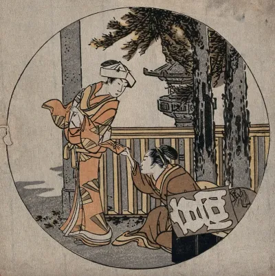 Two women at a shrine; a kite is resting on a box and bundle on the right; part of a ceremonial gate is visible on the left and a stone lantern is seen beyond