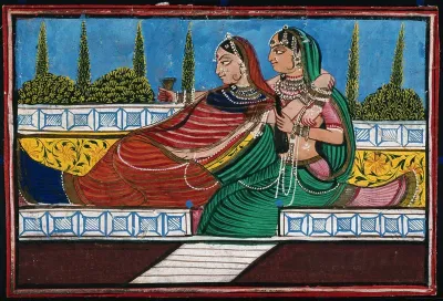 Two women embracing each other as one holds a glass and bottle