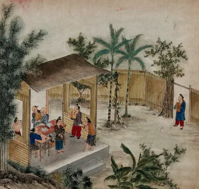 Two women from Formosa have a conversation in front of a thatched cottage on stilts