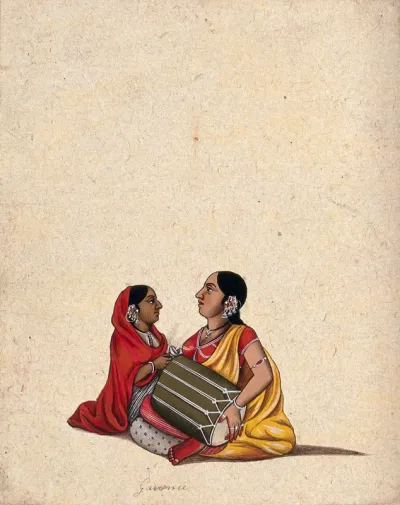 Two women playing the dholak (Indian drum) and cymbals