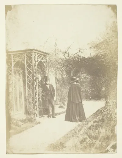 Unidentified Woman and Two Men Standing Outdoors