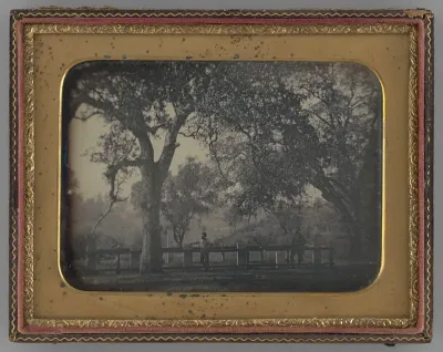 Untitled (Man Leaning Against a Fence in Front of a Cemetery)