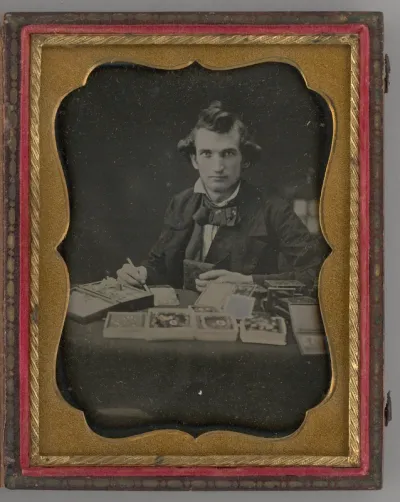 Untitled (Portrait of Seated Man Holding a Daguerreotype and Brush)