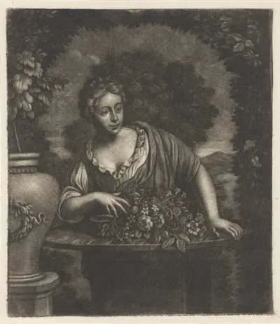 Vrouw in een tuin achter een tafel met bloemen
