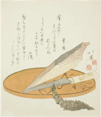 Wasabi root with dried bonito and knife on a lacquer tray
