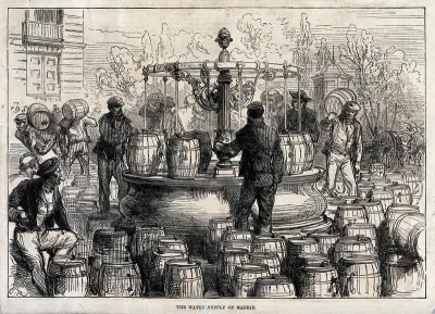Water-sellers filling barrels with water from a water fountain in Madrid