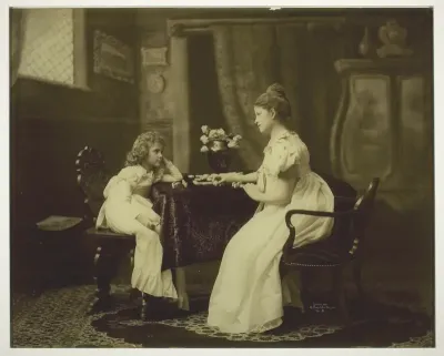Woman and Child Playing Dominoes at Table