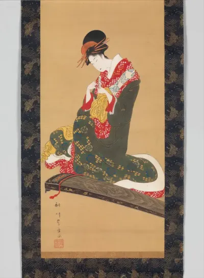 Woman Putting on Finger Plectrums to Play the Koto