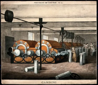 Women and children operating cotton-carding machines in a factory