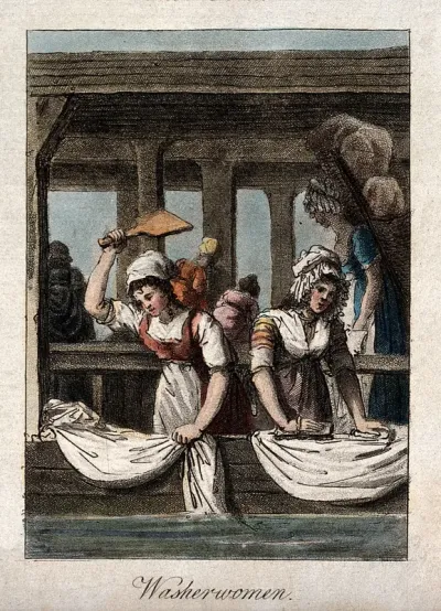 Women are beating and scrubbing sheets in a wash house