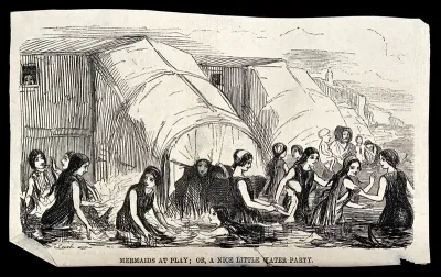 Women bathing in the sea near their bathing machines