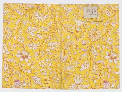 Yellow book cover with floral and vine pattern