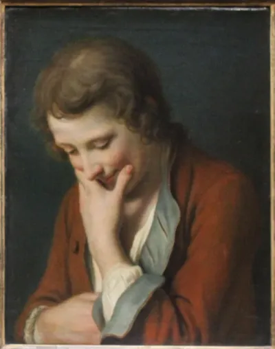 Young man with his left hand on his chin